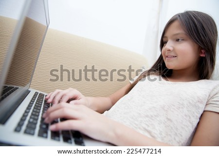 Teenager using her computer to check her e-mail