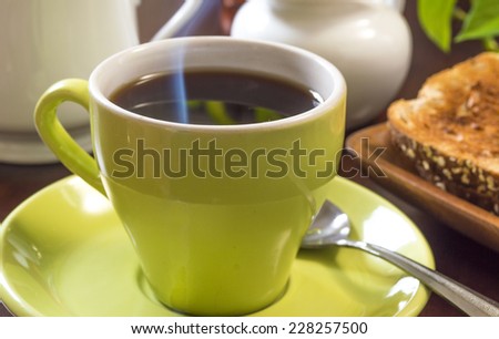 steaming hot coffee with toast \
