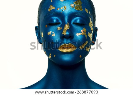 Beauty Alien Halloween Makeup. Blue Skin and gold Lips.