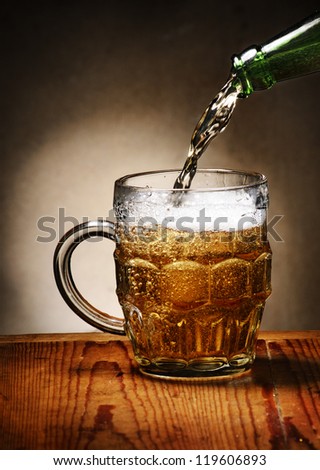 Pouring beer into beer mug