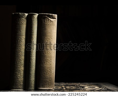 Old books in front of black background
