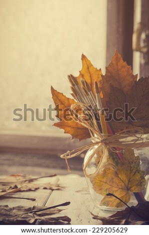 Art brushes and maple leaves. Art concept.