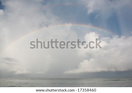 Colorful rainbow over ocean after storm