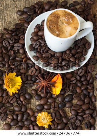 Cup of coffee and red cloves flowers in a vase with good morning note