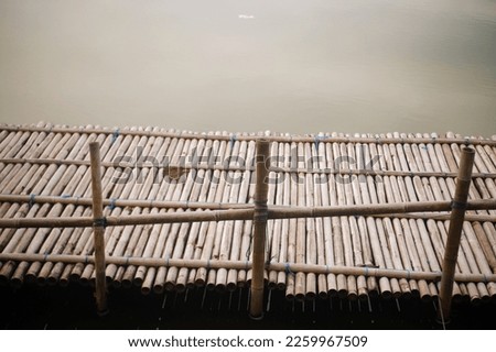 bamboo bridge at river in yogyakarta, jembatan tradisional bambu, di dermaga perahu laguna pantai glagah untuk berjalan penumpang dari daratan naik perahu mengelilingi laguna dengan membayar 30 k Stock fotó © 