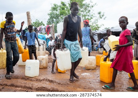 Juba, South Sudan - April 10, 2014: South Sudanese children get the daily ration of water