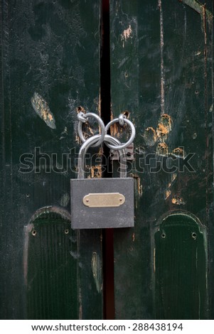 Color picture of a metal lock on a wooden door