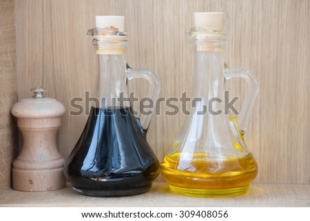 Color picture of oil and vinegar containers and a salt grinder