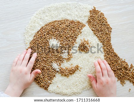 Similar – Image, Stock Photo Female hand make buckwheat balls on kitchen table background with herbs and spices, top view. Healthy homemade food