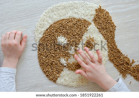 Similar – Image, Stock Photo Female hand make buckwheat balls on kitchen table background with herbs and spices, top view. Healthy homemade food