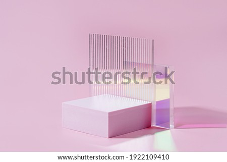 Geometric shapes podium for product display. Monochrome platform  with gloss acrylic sheets on pink background. Stylish background for presentation. Minimal style.
