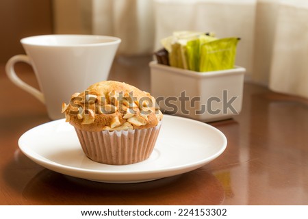 Banana cakes topping with cashew nut on table with cofee