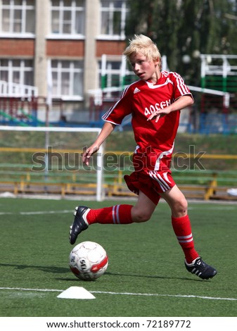 BELGOROD, RUSSIA - JULY 7: Unidentified boy plays football July, 7 2010 in Belgorod, Russia. The final of Chernozemje superiority, Football kinder team of 1998 year of birth.