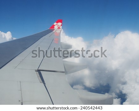 TOKYO, JAPAN - OCTOBER 30: Thai AirAsia X (TAAX) plane\'s wing with logo, the plane flying over Tokyo-Japan to Bangkok-Thailand on October 30 2014. AirAsia as Asia\'s Leading Low Cost Airline.
