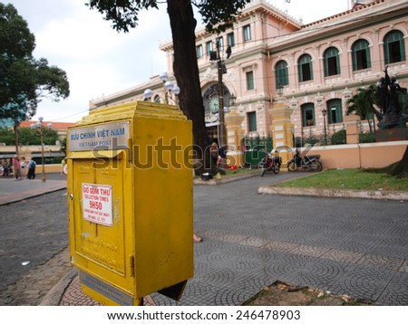 HO CHI MINH CITY, VIETNAM - NOVEMBER 29: Yellow postbox in front of Saigon Central Post Office in Ho Chi Minh City, Vietnam on November 29, 2013. This post office is neoclassical architectural style.
