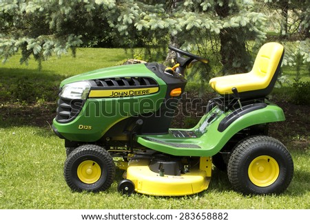 RIVER FALLS,WISCONSIN-JUNE 02,2015: A John Deere lawn tractor in River Falls,Wisconsin on June 02,2015. Deere and Company is Headquartered in Moline,Illinois.