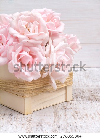 Pale pink roses bouquet in the wooden box tied with jute rope