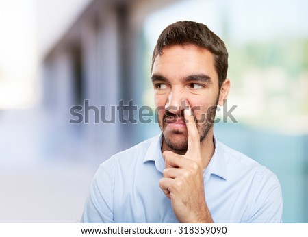Close up of a young man with gesture of bad smell
