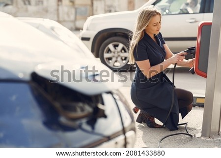 Elegant woman standing on a gas station Stock fotó © 