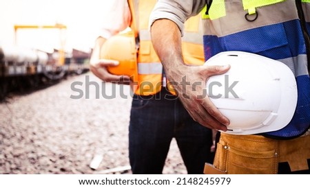 Engineer team holding hardhat Logistic expert by railway.Worker diversity group wearing vest,ppe for safety in site train garage.Expert construction project manager leadership.banner cover design. Stockfoto © 