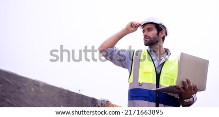 Handsome Male foreman engineer wearing helmet controls and maintains the operation project system using laptop on the background train garage.Banner cover design industrial team ,leadership concept. ストックフォト © 
