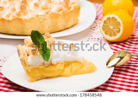 A piece of lemon meringue pie on white plate