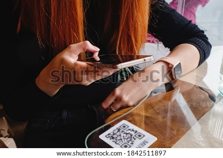 Woman scanning the barcode qr code in restaurant or cafe Сток-фото © 