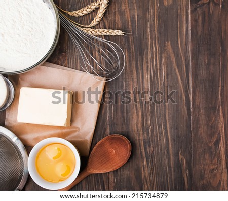 Ingredients and tools for baking on the wooden table, up view