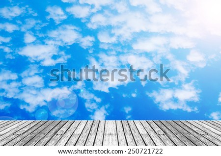 wood texture floor with  sunshine blue sky and cloud