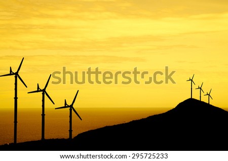 wind turbine on sunset sky with sea background