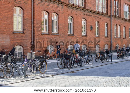 COPENHAGEN, DENMARK - AUGUST 12: Kids and bikes near school on August 12, 2014 in Copenhagen.