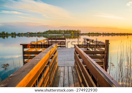 Sunset over the lake with pier