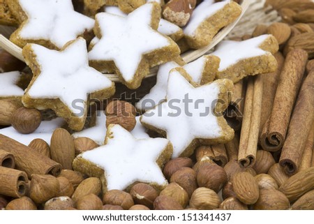 typical christmas cinnamon star cookies, nuts and cinnamon sticks