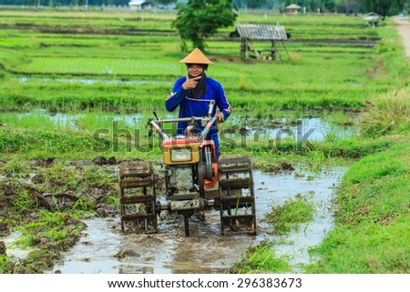 The farmer with a tractor after the rainy season to start walking-but to sow the. Thailand farmers around everywhere are starting to plow their rice-Lampang Thailand-July 14 national 2015.