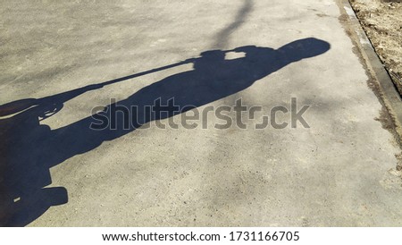 Similar – Image, Stock Photo Unrecognizable figures riding scooter on road