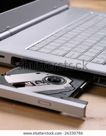 A laptop with cd tray open and ready for CD / DVD