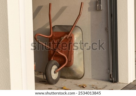 Similar – Image, Stock Photo An old rusty wheelbarrow with a fat black balloon tyre tries to hide in a lilac bush, but doesn’t quite succeed