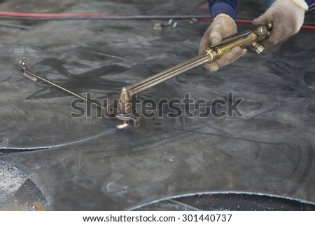 welder is cutting steel plate with gas cutting