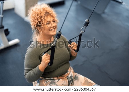 Similar – Image, Stock Photo Happy plus size curly young woman smiling to camera while using a laptop to prepare,and do work online at home, remote tasking. Modern city flat. Getting the bills paid. Entrepreneur freelancer women