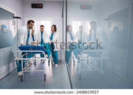 Similar – Image, Stock Photo Group of doctors transporting patient to operating room