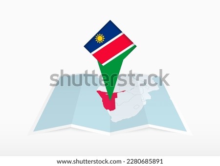 Namibia is depicted on a folded paper map and pinned location marker with flag of Namibia. Folded vector map.