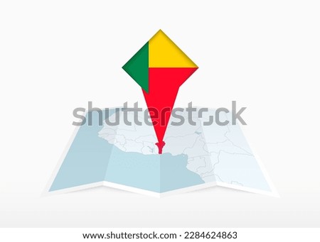 Benin is depicted on a folded paper map and pinned location marker with flag of Benin. Folded vector map.