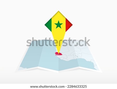 Senegal is depicted on a folded paper map and pinned location marker with flag of Senegal. Folded vector map.