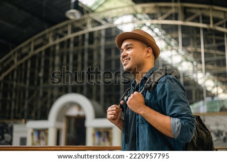 Similar – Image, Stock Photo Asian man with travel bag using smartphone against white wall