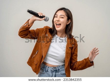 Similar – Image, Stock Photo Young woman singing with a microphone