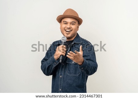 Similar – Image, Stock Photo Man holds a microphone in his hand ready to speak