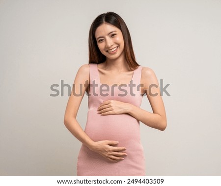 Similar – Image, Stock Photo Smiling pregnant woman touching belly on floor at home