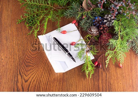 Christmas decoration with a letter to Santa and pine branches on a wooden board