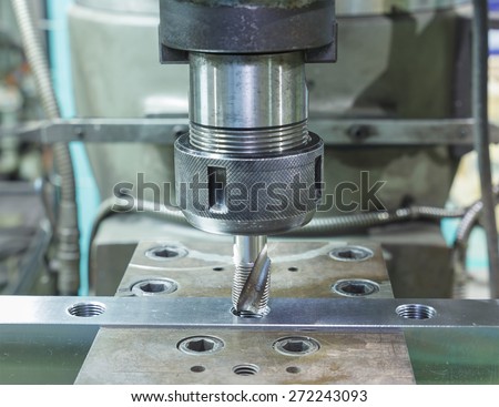 Tapping metal box by machine