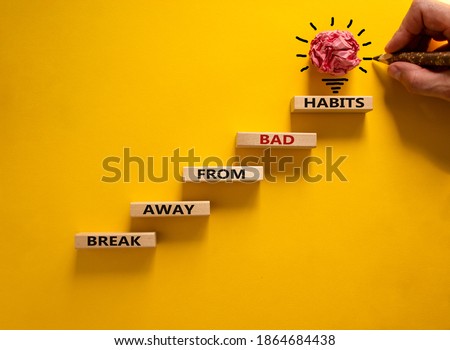 Business concept growth success process. Wood blocks stacking as step stair on yellow background, copy space. Male hand with pencil. Words 'break away from bad habits'. Copy space. Foto stock © 